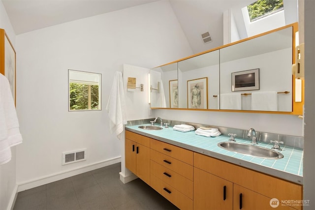 9000 NE Hidden Cove Rd, Bainbridge Island, WA 98110 - full bath featuring double vanity, a skylight, and high vaulted ceiling