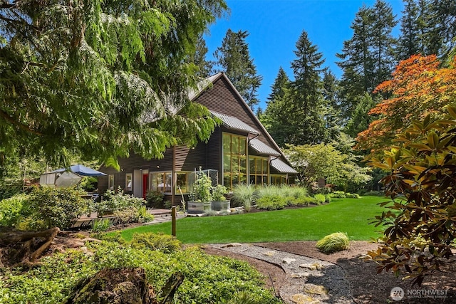 9000 NE Hidden Cove Rd, Bainbridge Island, WA 98110 - back of house with a metal roof and a yard