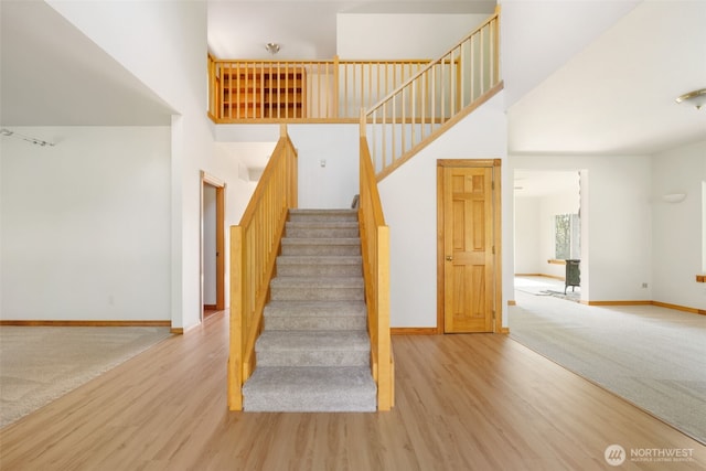 14502 45th St SW, Lakebay, WA 98349 - stairway featuring baseboards, wood finished floors, and a high ceiling