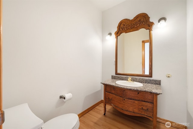14502 45th St SW, Lakebay, WA 98349 - bathroom with toilet, vanity, wood finished floors, and baseboards