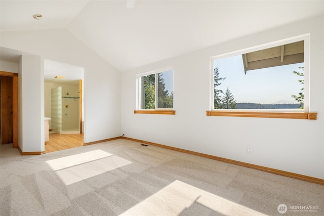 14502 45th St SW, Lakebay, WA 98349 - unfurnished bedroom with carpet floors, lofted ceiling, baseboards, and ensuite bath