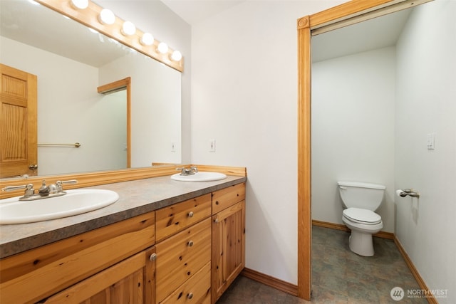 14502 45th St SW, Lakebay, WA 98349 - full bath with double vanity, toilet, and baseboards