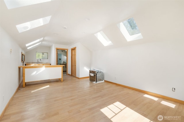 14502 45th St SW, Lakebay, WA 98349 - additional living space featuring a skylight, vaulted ceiling, light wood-style flooring, and baseboards