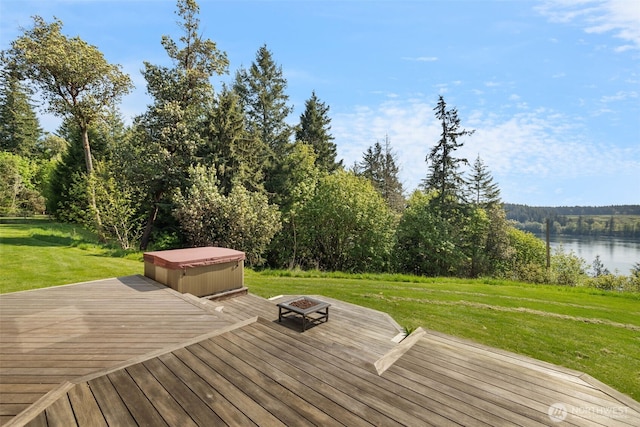 14502 45th St SW, Lakebay, WA 98349 - deck featuring a fire pit, a lawn, a water view, a hot tub, and a forest view
