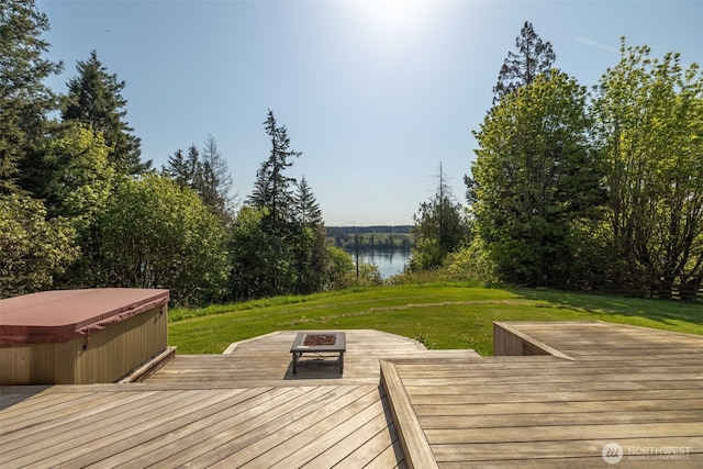 14502 45th St SW, Lakebay, WA 98349 - deck with a hot tub, a fire pit, a lawn, and a water view