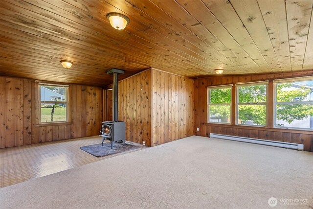 967 High Rd, Camano Island, WA 98282 - unfurnished room with a baseboard heating unit, carpet, wood ceiling, plenty of natural light, and a wood stove