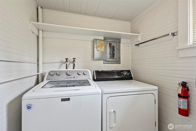 967 High Rd, Camano Island, WA 98282 - laundry room featuring electric panel, washing machine and clothes dryer, and wooden walls