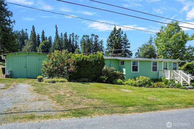 967 High Rd, Camano Island, WA 98282 - view of home's exterior featuring a storage unit and a yard