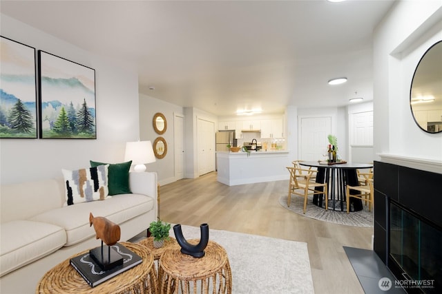 7711 NE 175th St Unit C106, Kenmore, WA 98028 - living room with light wood-style flooring and baseboards