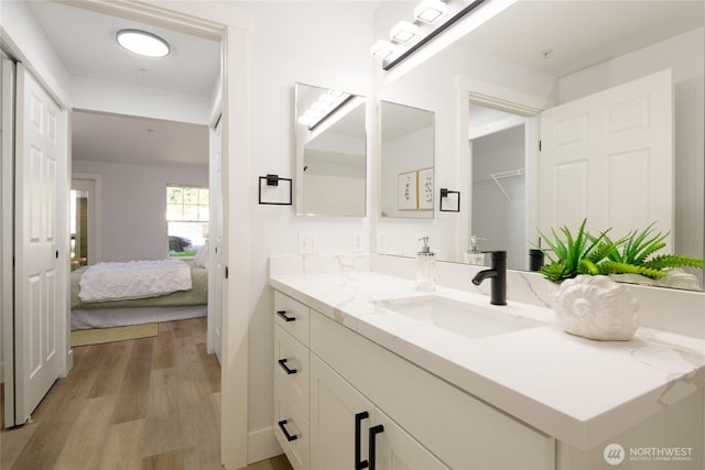 7711 NE 175th St Unit C106, Kenmore, WA 98028 - bathroom with vanity, wood finished floors, and ensuite bath