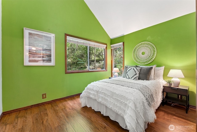 15602 26th Ave SW, Burien, WA 98166 - bedroom featuring wood finished floors, baseboards, and high vaulted ceiling