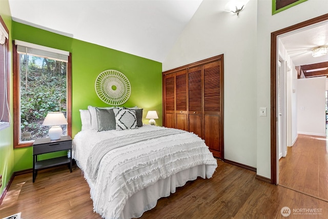 15602 26th Ave SW, Burien, WA 98166 - bedroom with a closet, baseboards, wood finished floors, and vaulted ceiling