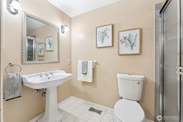 15602 26th Ave SW, Burien, WA 98166 - full bathroom with toilet, baseboards, tile patterned flooring, and a shower with shower door