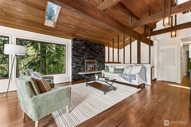 15602 26th Ave SW, Burien, WA 98166 - living room featuring wood ceiling with exposed beams, a skylight, wood finished floors, a stone fireplace, and high vaulted ceiling