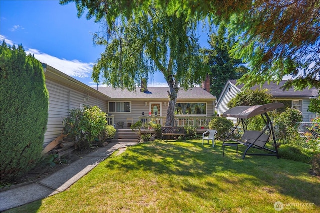 12421 2nd Ave S, Seattle, WA 98168 - rear view of property featuring a lawn, a wooden deck, and a chimney