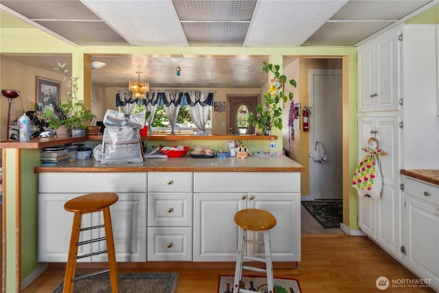 12421 2nd Ave S, Seattle, WA 98168 - bar with light wood-type flooring and a chandelier
