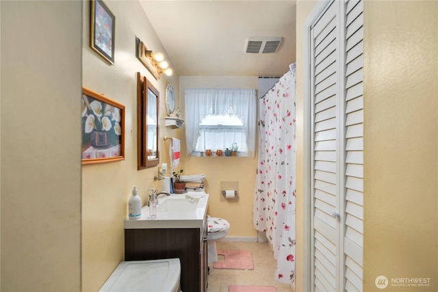 12421 2nd Ave S, Seattle, WA 98168 - bathroom featuring vanity, toilet, a closet, curtained shower, and tile patterned flooring