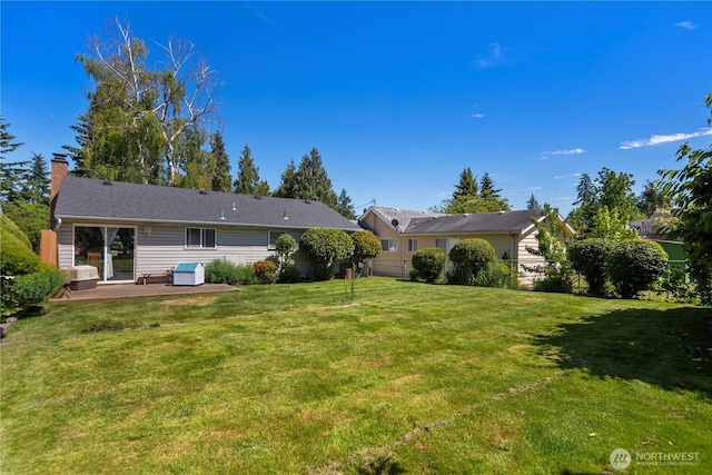 12421 2nd Ave S, Seattle, WA 98168 - rear view of house with a patio area, a lawn, and a chimney