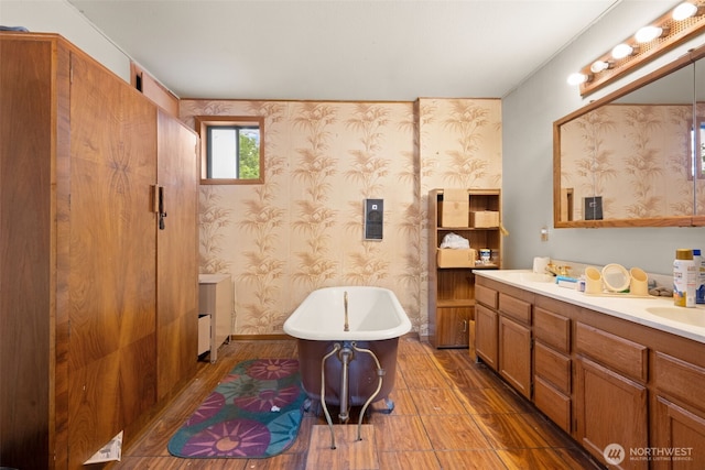3626 E J St, Tacoma, WA 98404 - bathroom featuring vanity, a freestanding bath, wood finished floors, and wallpapered walls