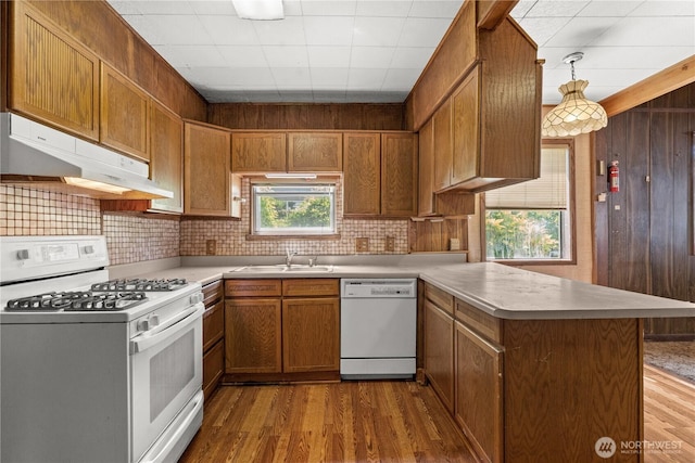3626 E J St, Tacoma, WA 98404 - kitchen with white appliances, under cabinet range hood, a peninsula, light countertops, and backsplash