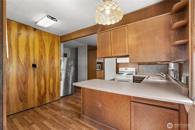3626 E J St, Tacoma, WA 98404 - kitchen featuring stainless steel appliances, open shelves, dark wood-style floors, a peninsula, and brown cabinets
