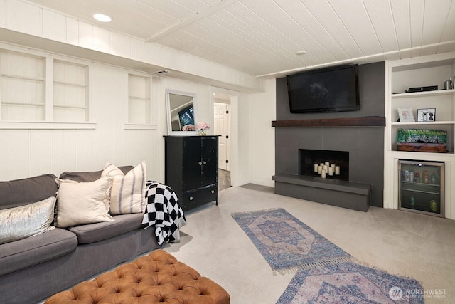 8824 224th St SW, Edmonds, WA 98026 - living area with a tile fireplace, built in shelves, wood ceiling, and carpet