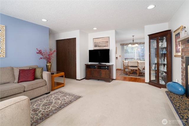 2623 25th Ct SW, Olympia, WA 98512 - carpeted living area with a chandelier, a textured ceiling, and recessed lighting