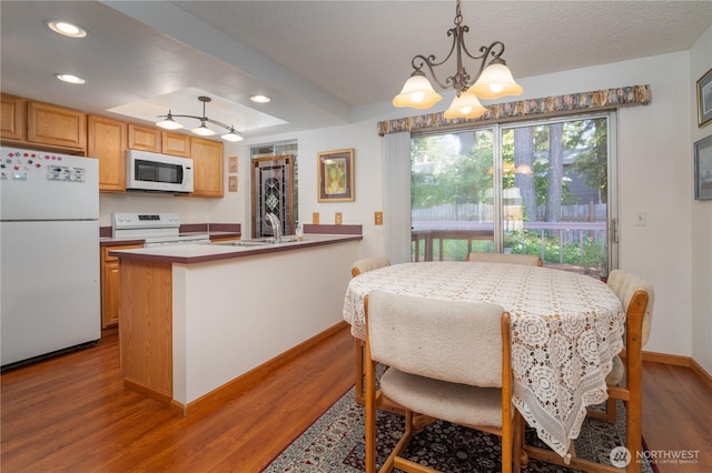 2623 25th Ct SW, Olympia, WA 98512 - dining space with a chandelier, wood finished floors, baseboards, and recessed lighting