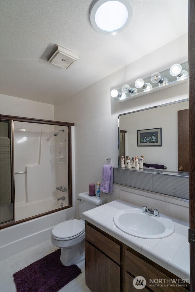 2623 25th Ct SW, Olympia, WA 98512 - bathroom featuring vanity, bath / shower combo with glass door, and toilet
