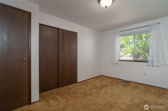2623 25th Ct SW, Olympia, WA 98512 - unfurnished bedroom featuring carpet, a textured ceiling, and a closet