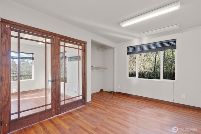 325 E State Route 4, Cathlamet, WA 98612 - unfurnished room featuring wood finished floors, french doors, and baseboards