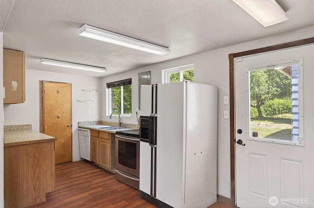 325 E State Route 4, Cathlamet, WA 98612 - kitchen with white appliances, a sink, dark wood-style flooring, light countertops, and a textured ceiling