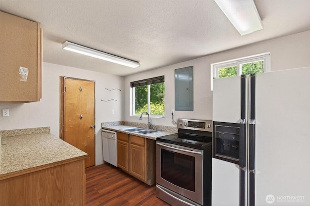 325 E State Route 4, Cathlamet, WA 98612 - kitchen featuring white appliances, a sink, electric panel, dark wood-style floors, and light countertops