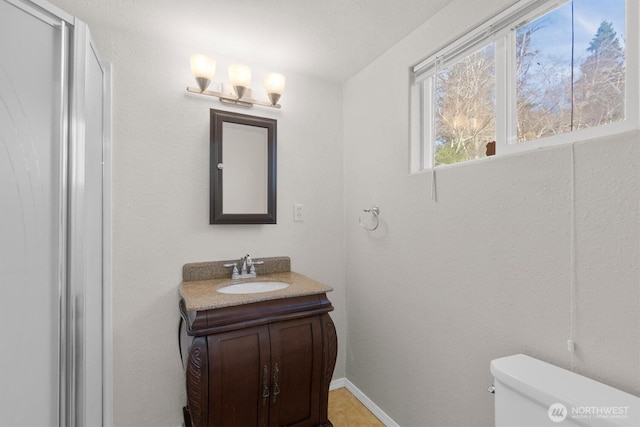 325 E State Route 4, Cathlamet, WA 98612 - bathroom with toilet, vanity, and baseboards