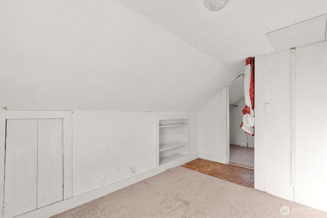325 E State Route 4, Cathlamet, WA 98612 - additional living space with built in shelves, vaulted ceiling, baseboards, and carpet floors