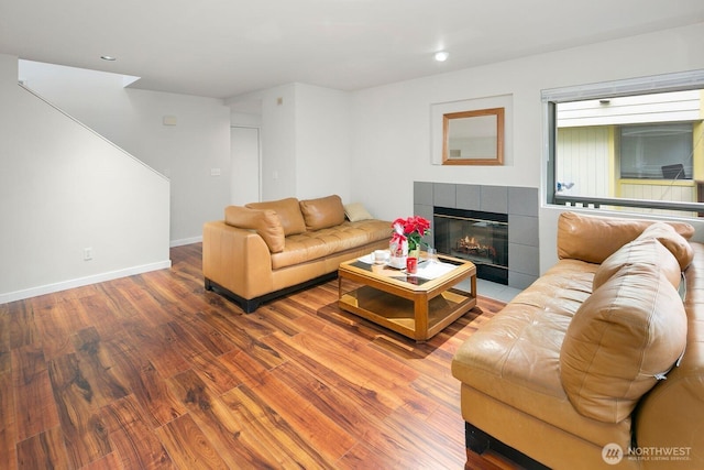 2367 S Forest St, Seattle, WA 98144 - living room featuring wood finished floors, a tiled fireplace, baseboards, and recessed lighting