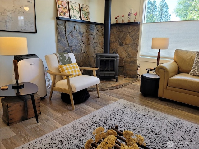 238 Castle Ave, Winthrop, WA 98862 - sitting room featuring a wood stove, wood finished floors, and healthy amount of natural light