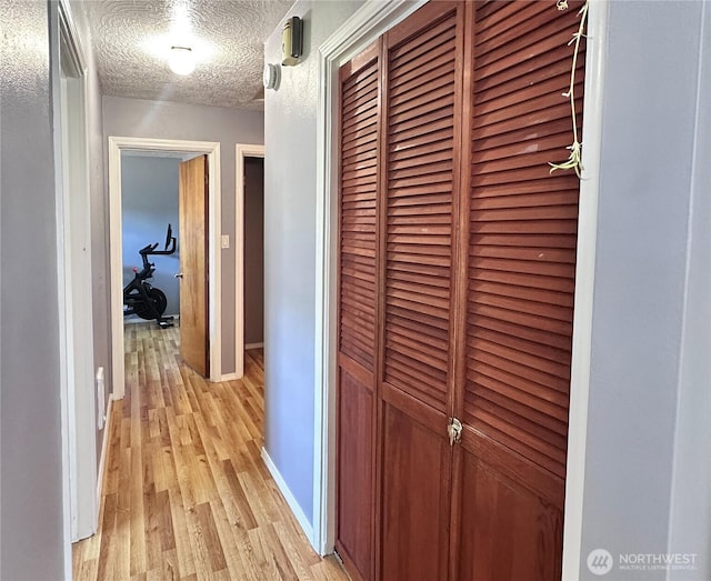 2036 30th Ave, Longview, WA 98632 - corridor featuring light wood-style floors, a textured ceiling, and baseboards