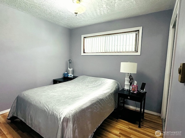 2036 30th Ave, Longview, WA 98632 - bedroom featuring wood finished floors, a textured ceiling, and baseboards