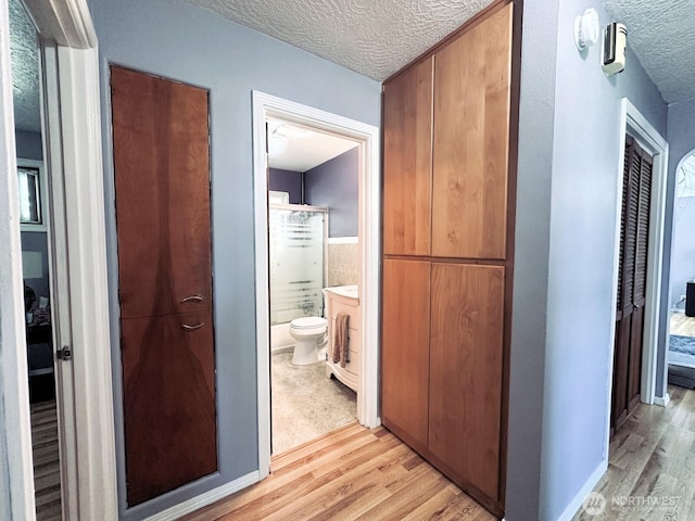 2036 30th Ave, Longview, WA 98632 - hallway with a textured ceiling and light wood-style floors