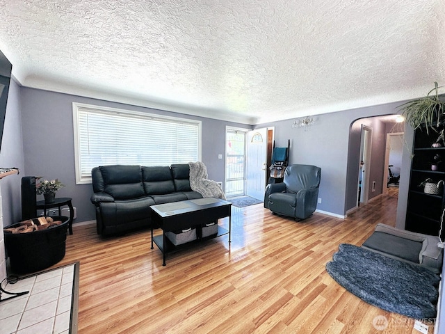 2036 30th Ave, Longview, WA 98632 - living area with light wood-style flooring, a textured ceiling, and baseboards
