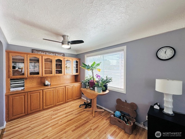 2036 30th Ave, Longview, WA 98632 - office area with a textured ceiling, light wood finished floors, ceiling fan, and baseboards