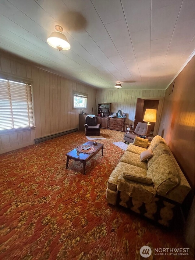 1204 Howard St, Raymond, WA 98577 - carpeted living room featuring a baseboard heating unit and wooden walls
