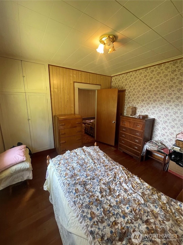 1204 Howard St, Raymond, WA 98577 - bedroom with wood finished floors, a closet, and wallpapered walls