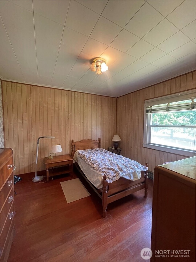 1204 Howard St, Raymond, WA 98577 - bedroom with wood finished floors and wood walls