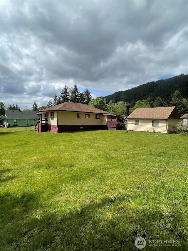1204 Howard St, Raymond, WA 98577 - view of grassy yard with a wooded view