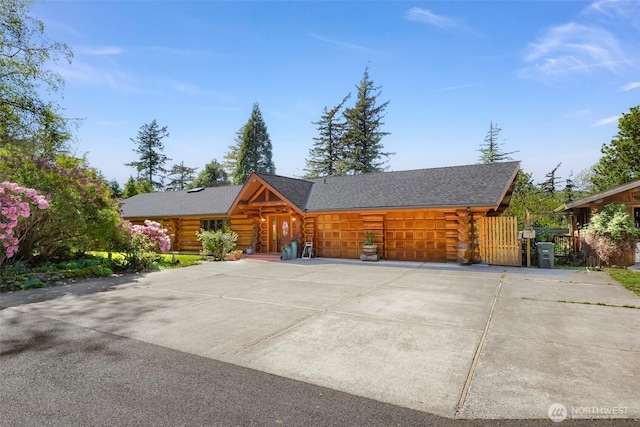 1416 Marietta Ave, Bellingham, WA 98226 - cabin with log siding, a garage, driveway, and roof with shingles