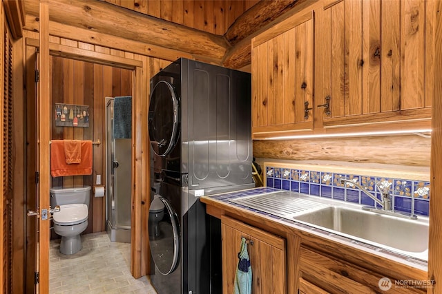 1416 Marietta Ave, Bellingham, WA 98226 - washroom featuring stacked washer and clothes dryer and brick patterned floors