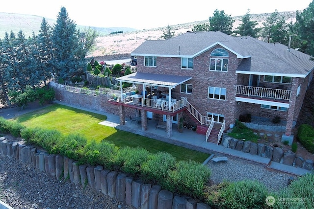 440 W Line Rd, Ephrata, WA 98823 - back of house featuring a patio, stairs, a yard, a deck with mountain view, and brick siding
