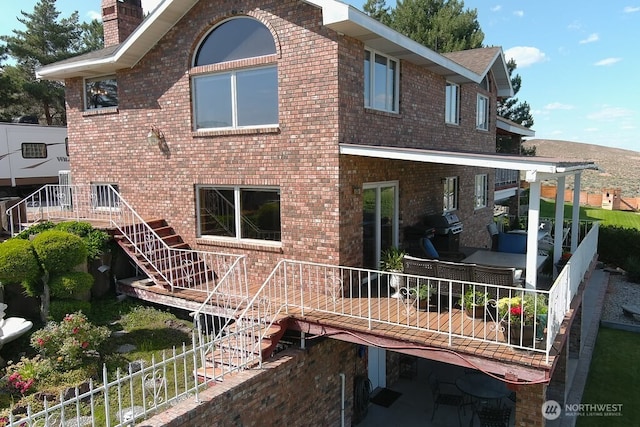 440 W Line Rd, Ephrata, WA 98823 - rear view of house featuring stairs, brick siding, and a chimney